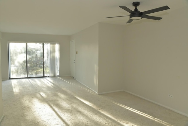 spare room with ceiling fan and carpet