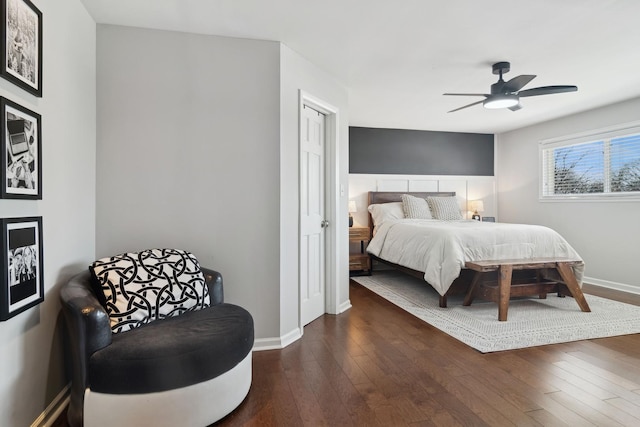 bedroom with ceiling fan and dark hardwood / wood-style flooring