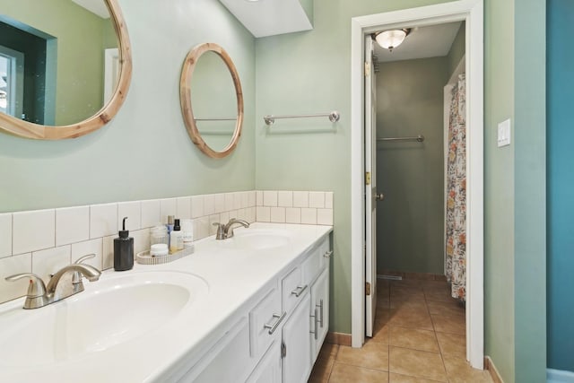 bathroom with tile patterned flooring, vanity, and tasteful backsplash