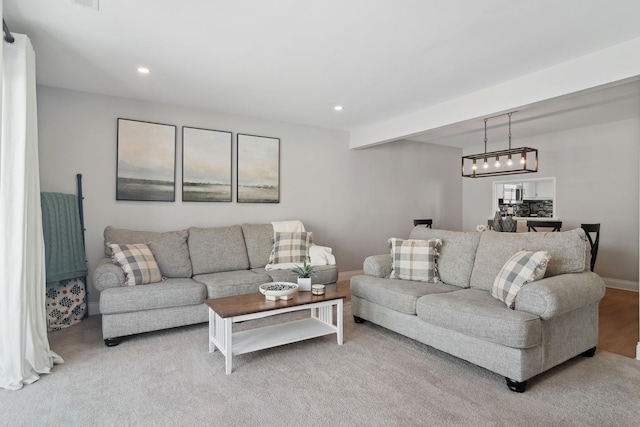 living room featuring light colored carpet and beam ceiling