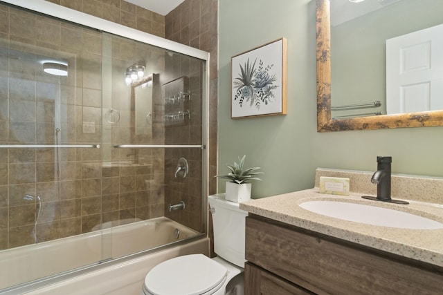 full bathroom with toilet, vanity, and shower / bath combination with glass door