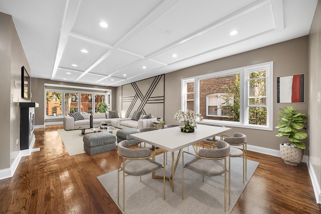 dining space with beam ceiling, dark hardwood / wood-style floors, and coffered ceiling