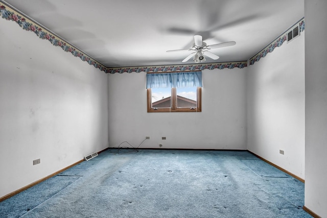 unfurnished room with ceiling fan and carpet