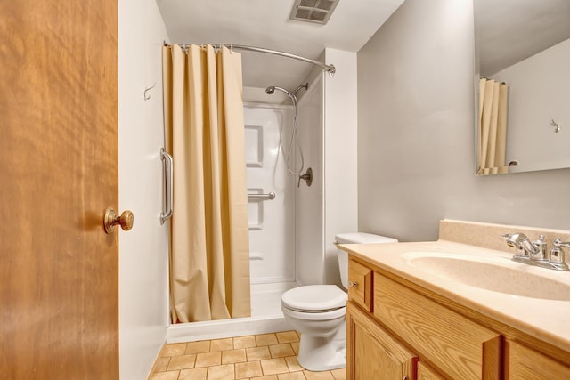 bathroom with toilet, curtained shower, tile patterned floors, and vanity