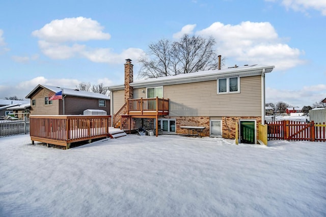 snow covered house with a deck