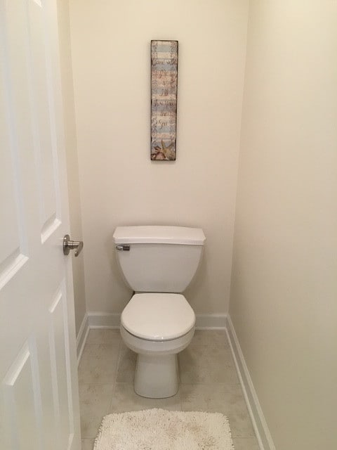 bathroom featuring tile patterned flooring and toilet