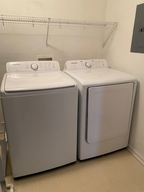 washroom featuring separate washer and dryer and electric panel