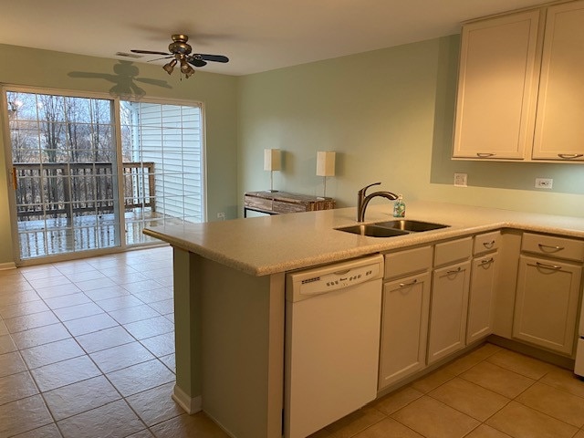 kitchen featuring ceiling fan, sink, kitchen peninsula, white dishwasher, and light tile patterned floors