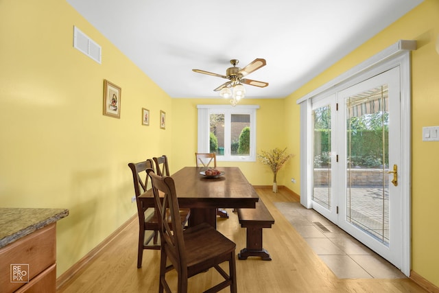 dining area with french doors, light hardwood / wood-style flooring, and ceiling fan