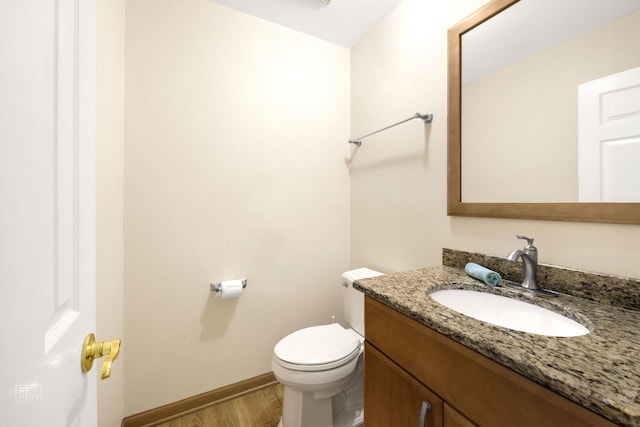 bathroom featuring hardwood / wood-style floors, vanity, and toilet