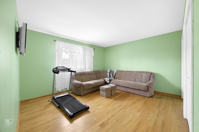 workout room featuring light wood-type flooring