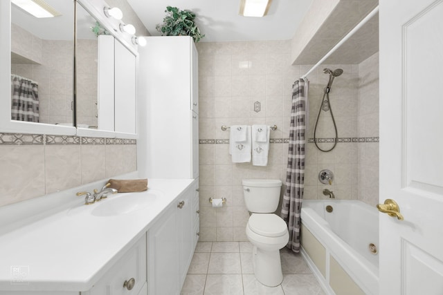 full bathroom featuring tile patterned floors, tile walls, toilet, vanity, and shower / tub combo