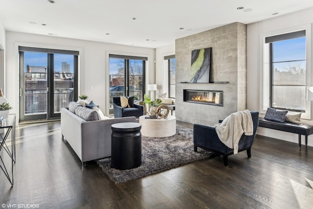 living room with dark hardwood / wood-style floors and a fireplace