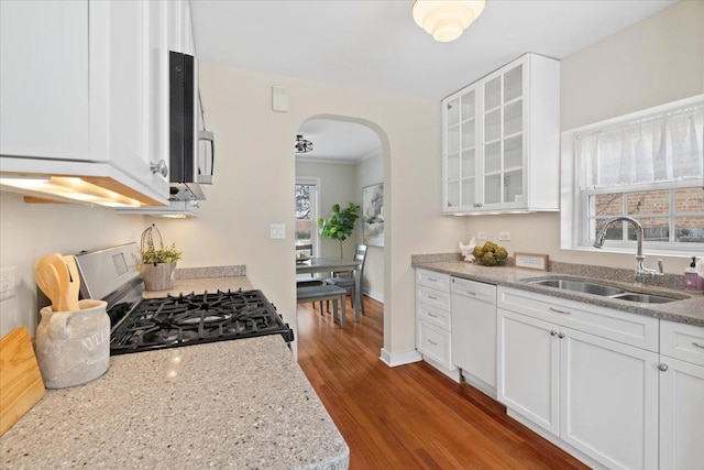 kitchen with white cabinetry, sink, white dishwasher, and gas range oven