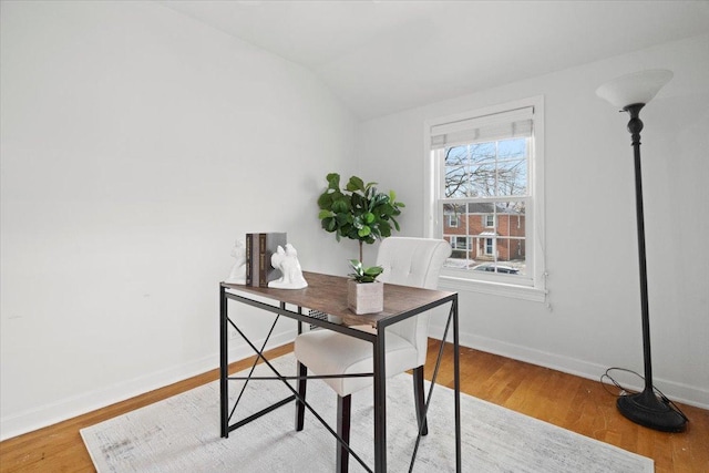 office featuring vaulted ceiling and hardwood / wood-style flooring