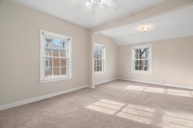 carpeted empty room featuring ceiling fan and lofted ceiling