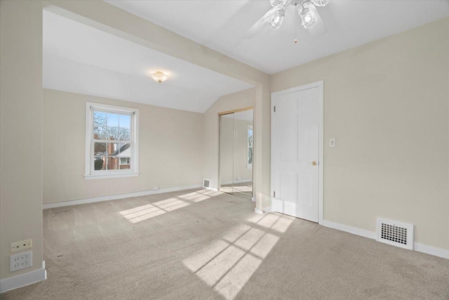 unfurnished room with ceiling fan, carpet floors, and vaulted ceiling