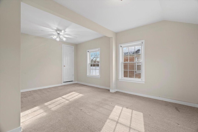 carpeted empty room featuring vaulted ceiling and ceiling fan