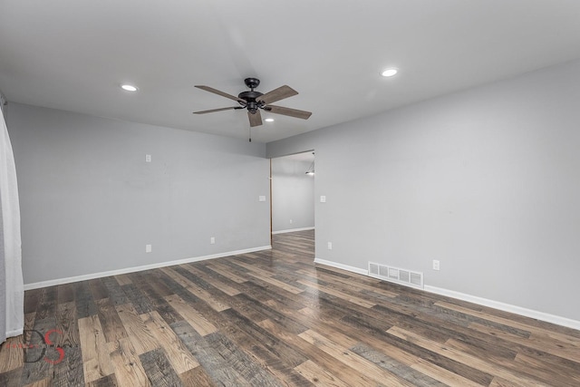 empty room featuring ceiling fan and dark wood-type flooring