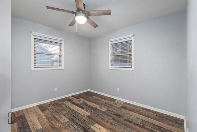 empty room with dark hardwood / wood-style floors and ceiling fan