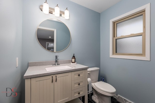 bathroom with vanity and toilet