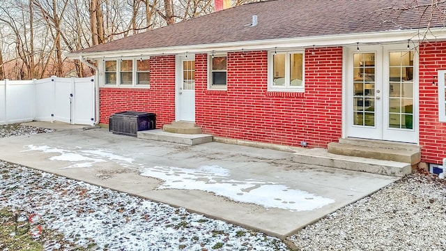 view of snow covered back of property