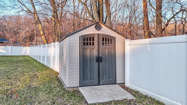 view of outbuilding featuring a lawn