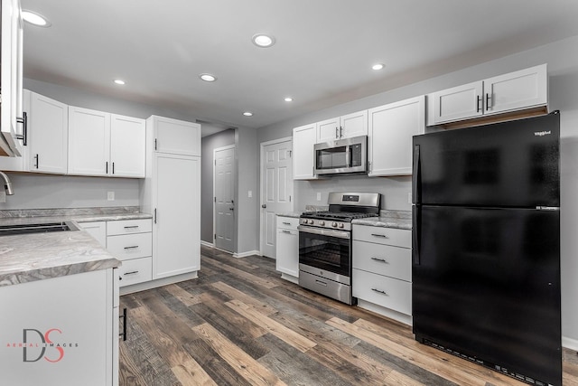 kitchen featuring sink, dark hardwood / wood-style flooring, white cabinets, and appliances with stainless steel finishes