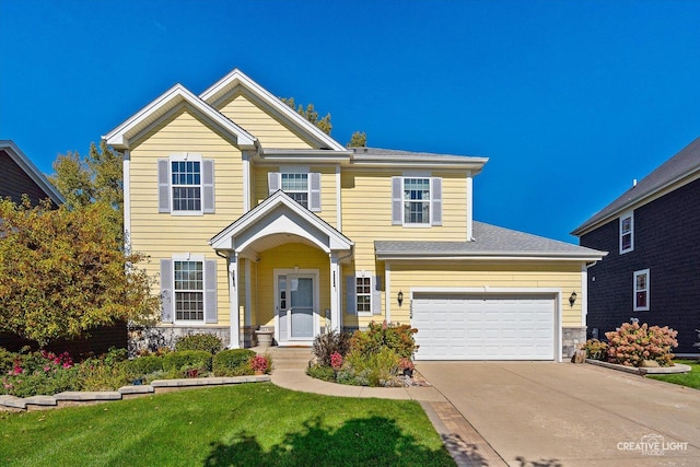 view of front of house featuring a front lawn and a garage