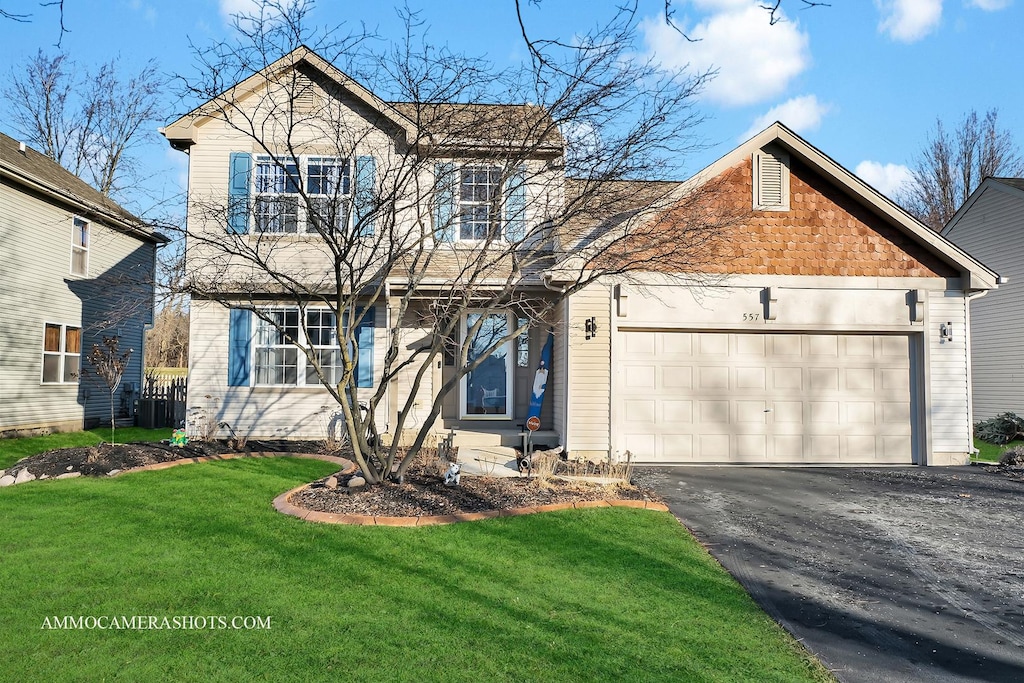 view of front property with a garage and a front lawn