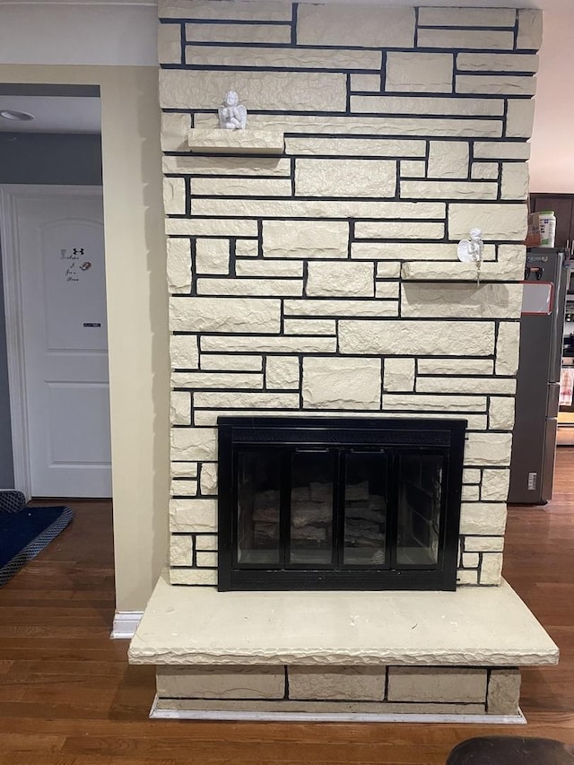 room details with a fireplace and hardwood / wood-style flooring