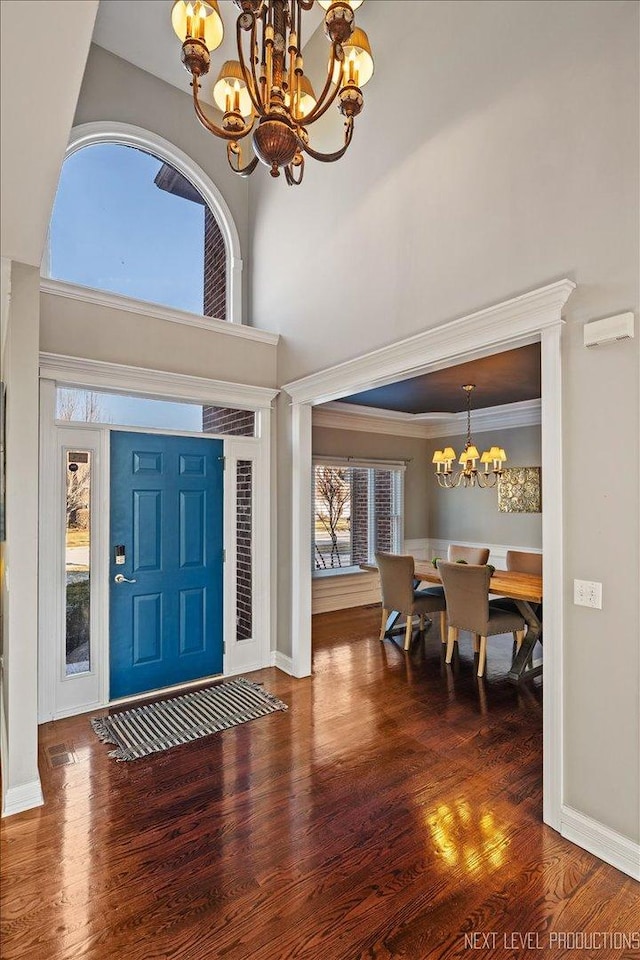 entryway featuring dark hardwood / wood-style floors and a chandelier