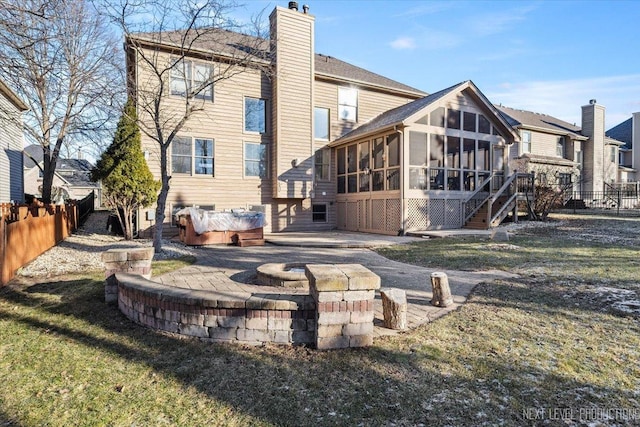 rear view of property featuring a sunroom, a yard, and a patio