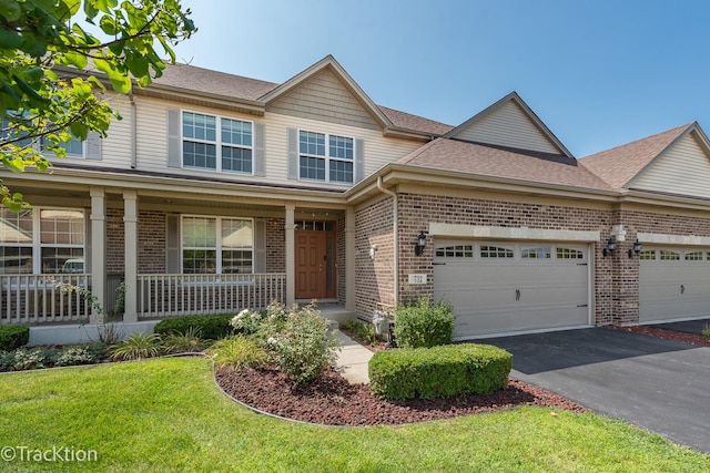 view of front of home featuring covered porch and a garage