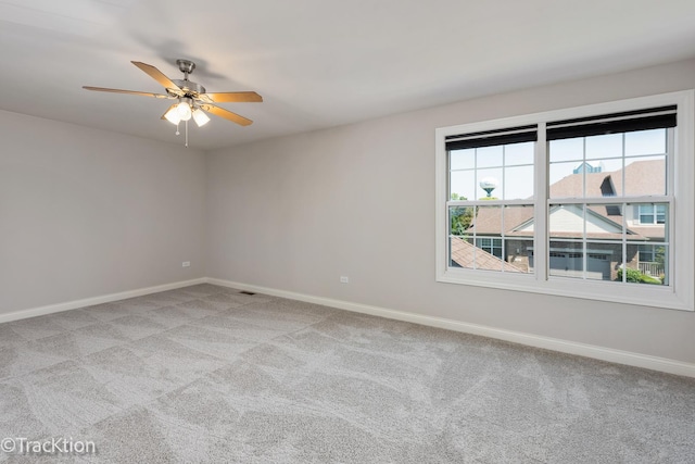 empty room with ceiling fan and light colored carpet