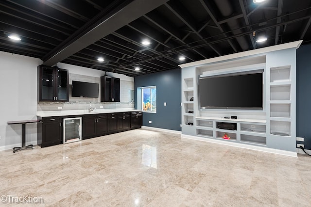 bar featuring tasteful backsplash, dark brown cabinets, sink, beam ceiling, and wine cooler