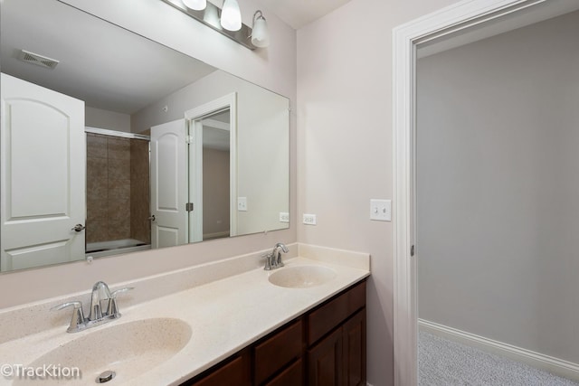 bathroom featuring a shower and vanity