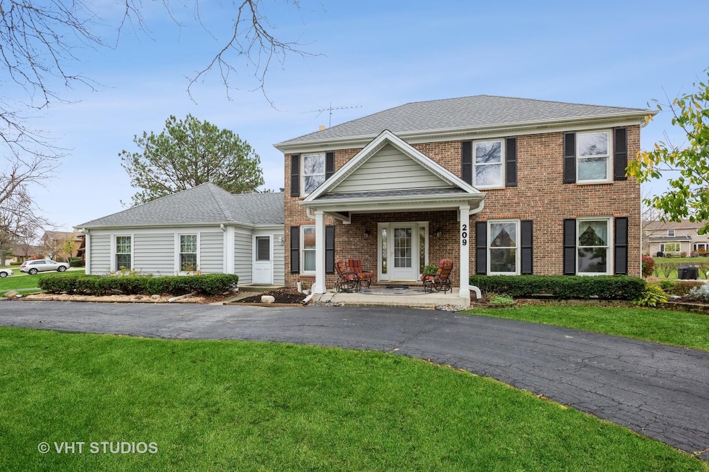 colonial-style house with a front yard