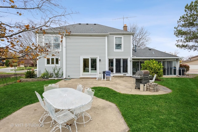 back of house with a yard and a patio