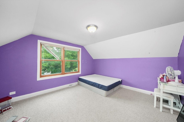 bedroom featuring carpet flooring and lofted ceiling