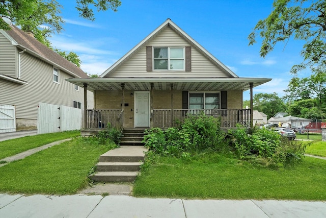 bungalow with a front lawn and a porch