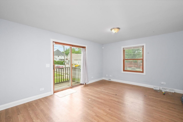 empty room with light hardwood / wood-style flooring