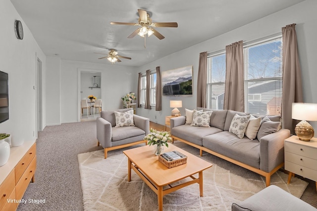 living room with ceiling fan and light colored carpet