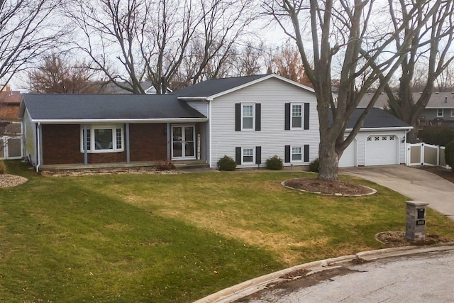 tri-level home featuring a garage and a front yard