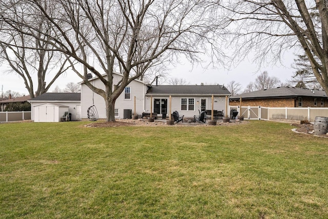 rear view of property with a yard, a patio, and a shed