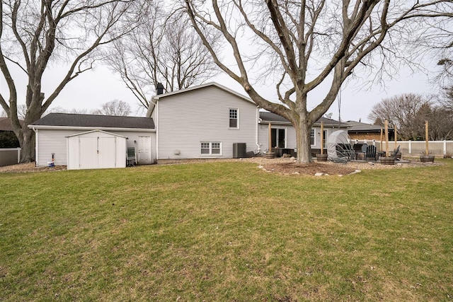 back of property featuring a lawn, cooling unit, a patio, and a storage unit