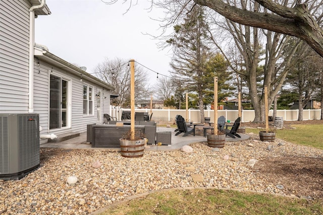 view of yard with central air condition unit, a patio area, and an outdoor living space with a fire pit