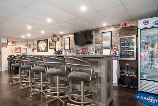 bar featuring a paneled ceiling and wine cooler