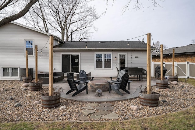 back of house featuring a patio and an outdoor fire pit