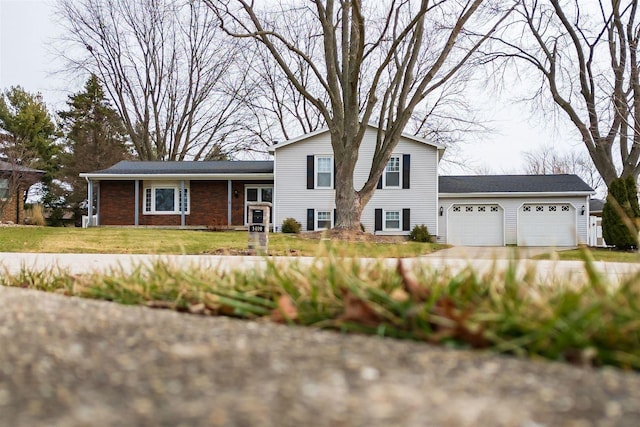 split level home with a front lawn and a garage